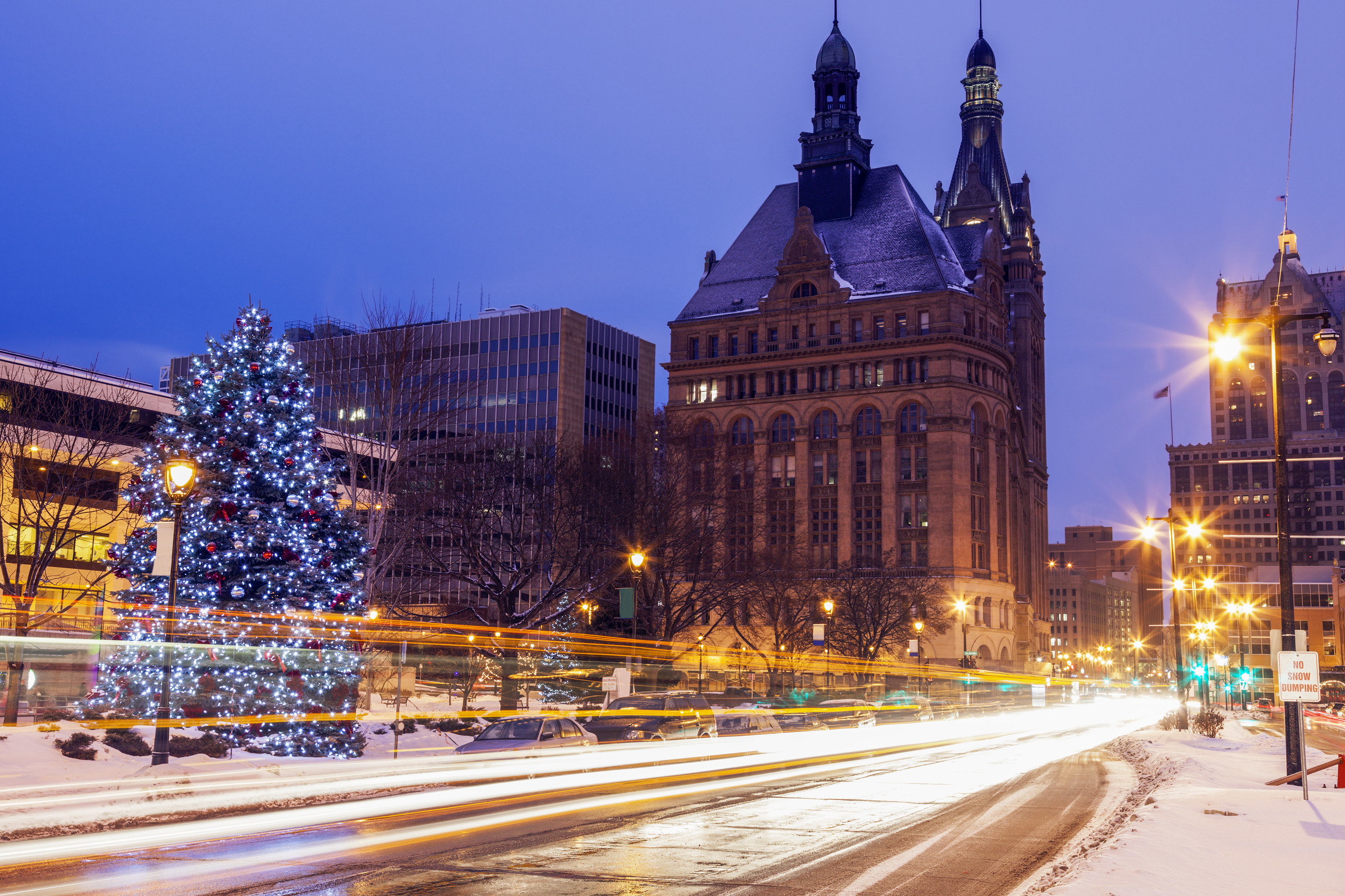 Large Christmas tree in Milwaukee with buildings in the background