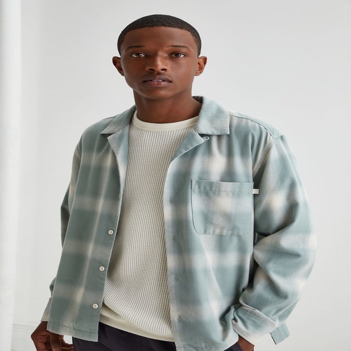 model wearing the light blue and white all-over plaid shirt
