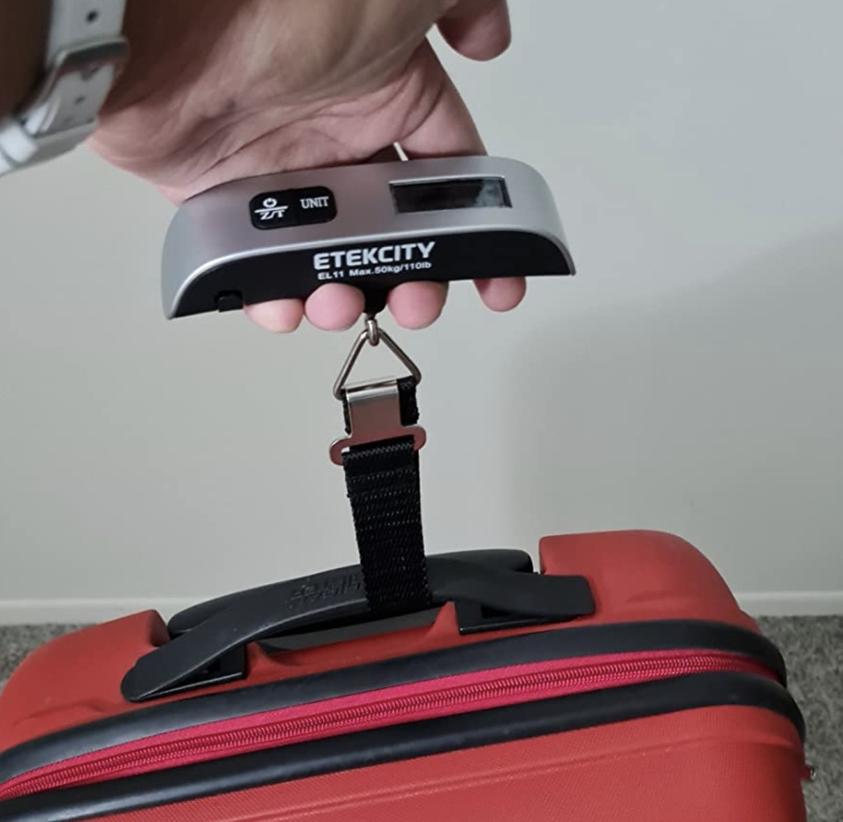 reviewer using the luggage scale