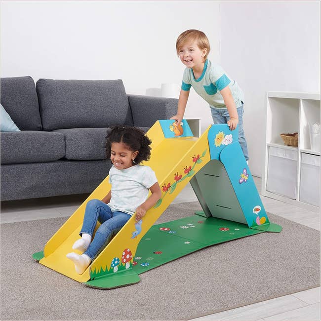 Two kids on indoor folding slide