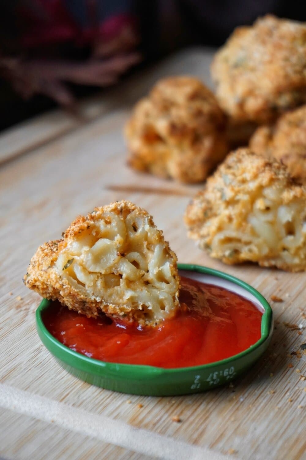 Crispy mac &#x27;n&#x27; cheese bites with ketchup for dipping.