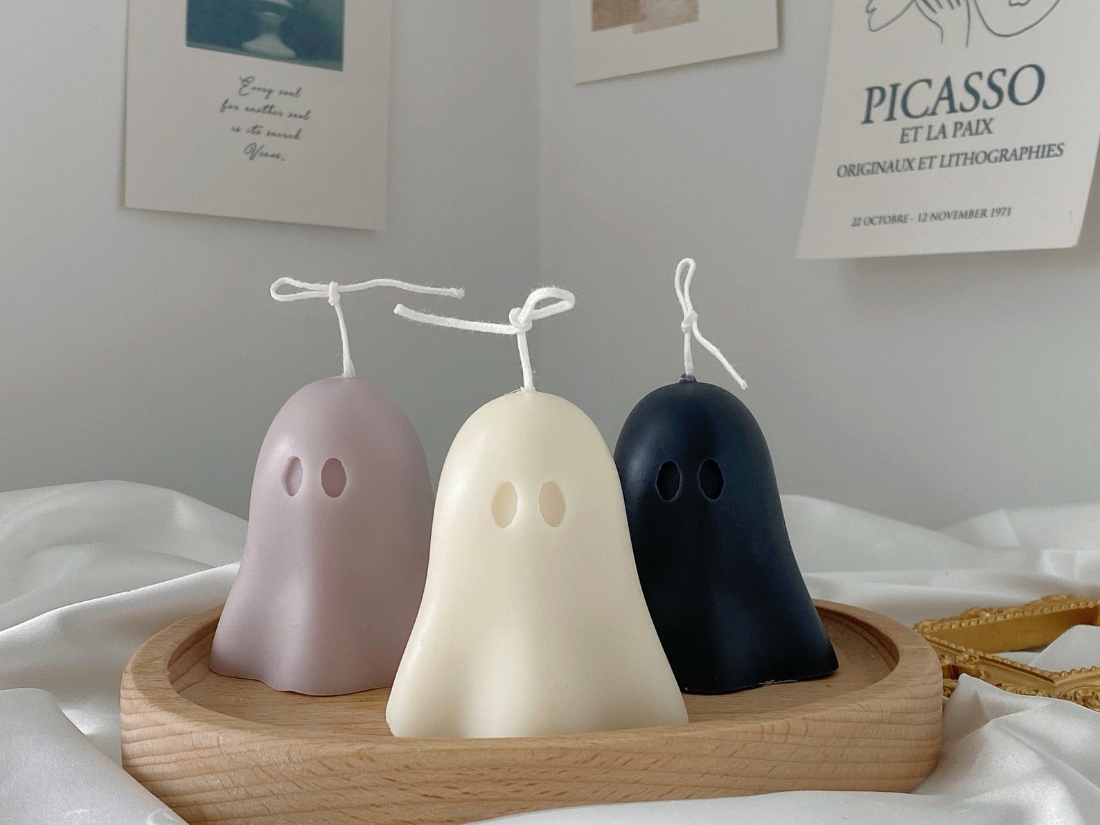 three ghost candles in various colors