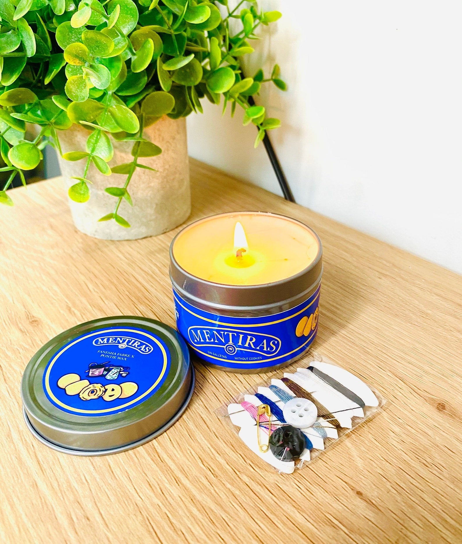sugar cookie candle next to mini sewing kit