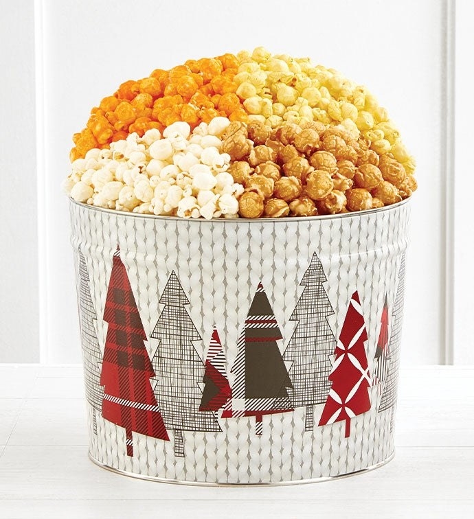 white popcorn tin with plaid christmas trees on it and four different kinds of popcorn in it
