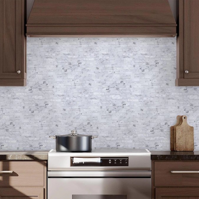 The peel-and-stick tile in the color Stacked Carrara