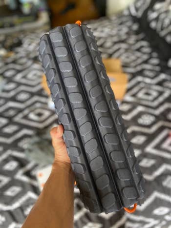 reviewer holding the grey foam roller