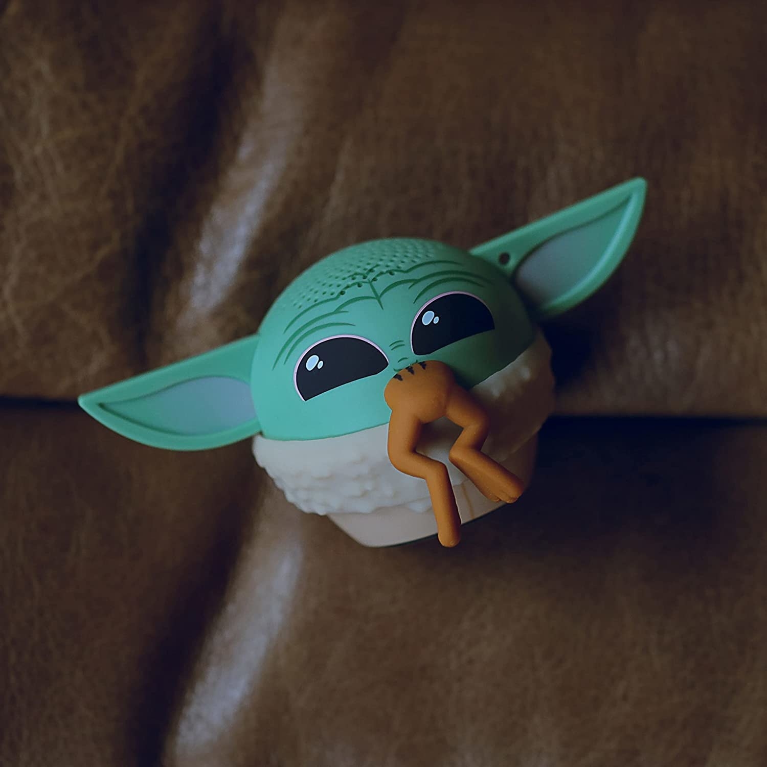 An image of the speaker designed to look like Baby Yoda eating a frog