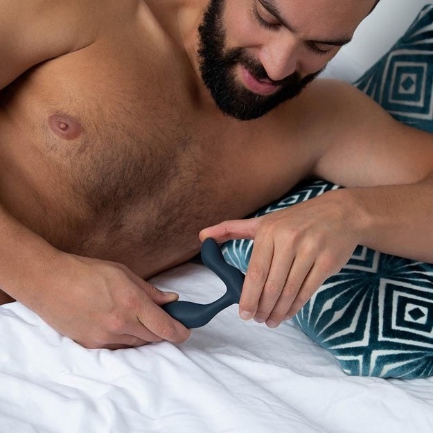 Model holding dark gray prostate massager