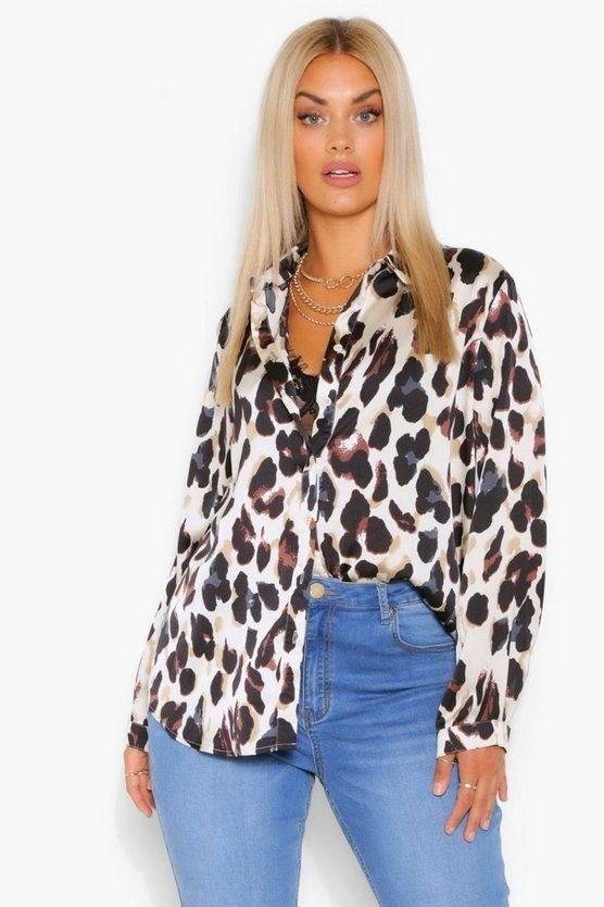 Model wearing the leopard print shirt half tucked in, half tucked out
