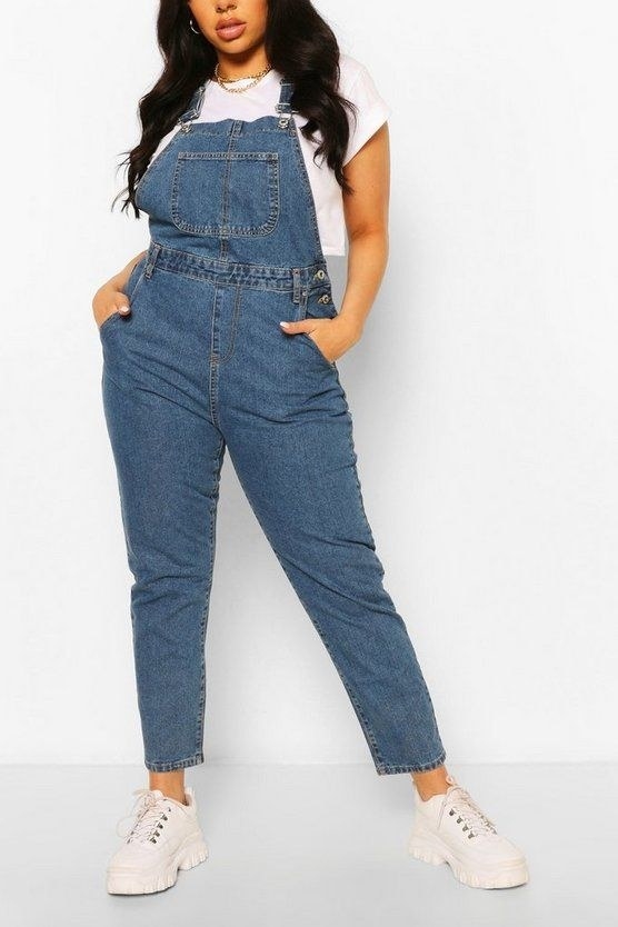 Model wearing the blue overalls with a white tee