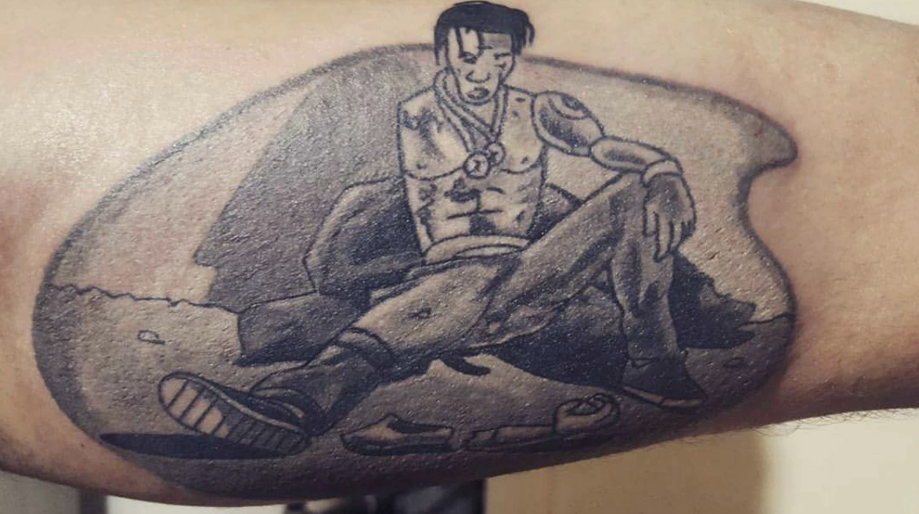 Horrible tattoo of Travis Scott as a cartoon character, looking down