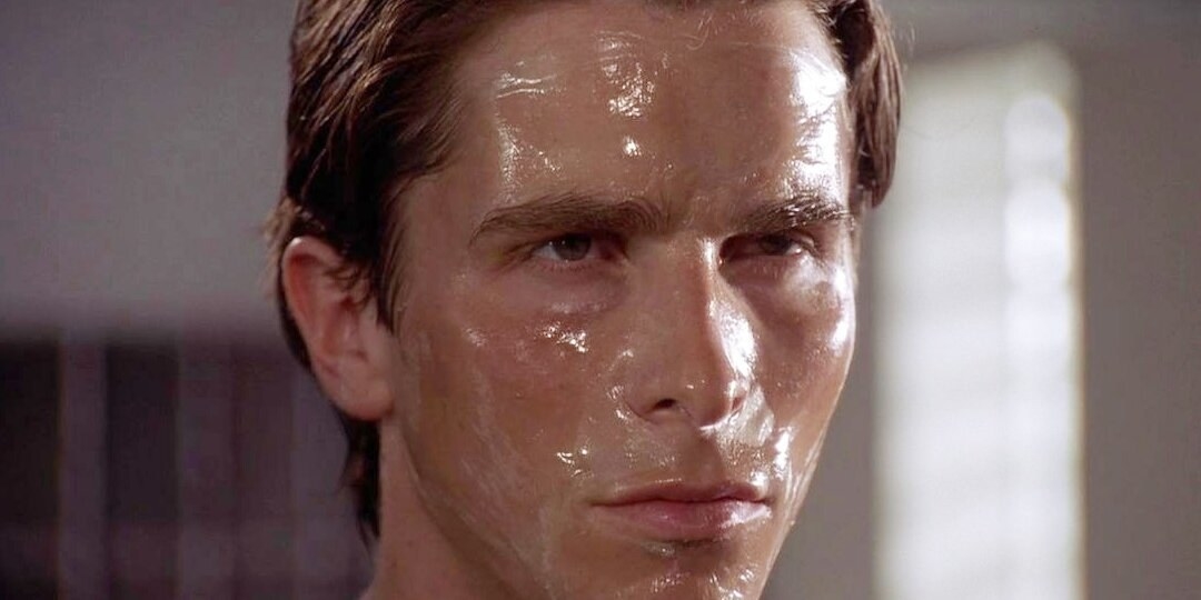 A man facing the mirror with a face wash peel on his face.