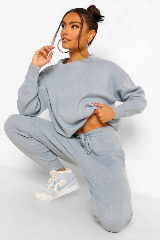 a model wearing the track suit in pastel blue
