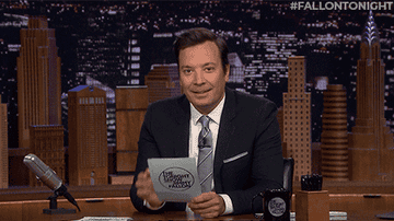 jimmy fallon laughing at his desk