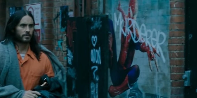 Morbius walking down an alley and passing a grafitti painting of Spider-Man in &quot;Morbius&quot;