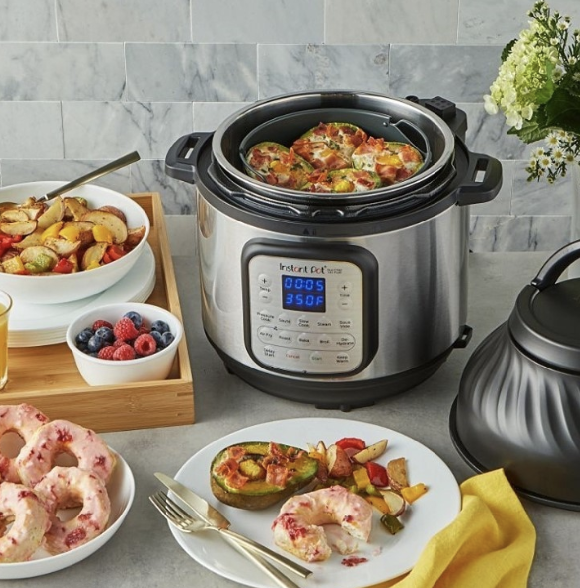 The cylinder shaped Instant pot with a control panel showing settings and temp
