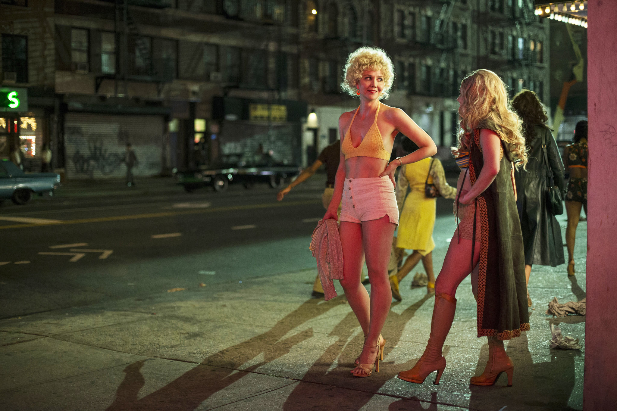 People standing on a sidewalk in a scene from The Deuce