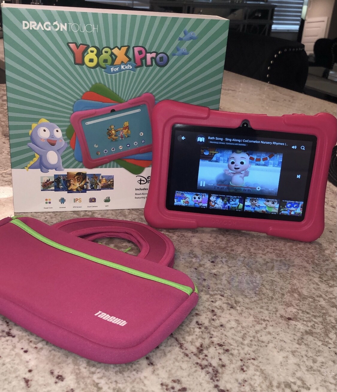 Reviewer photo of pink tablet with video playing next to pink tablet sleeve and product box