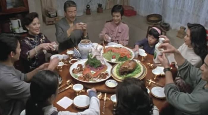 A family eats around a dinner table before a feast in the movie.