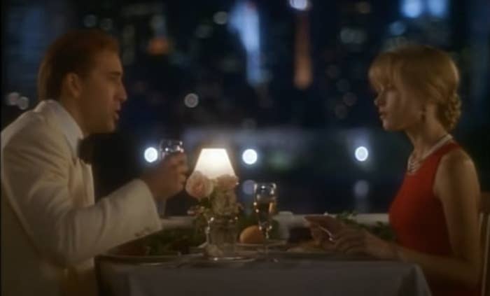 Actors Nicolas Cage and Bridget Fonda sit across from each other in the movie.