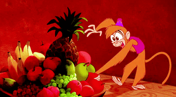 Abu from Aladdin stuffing his face with fruits