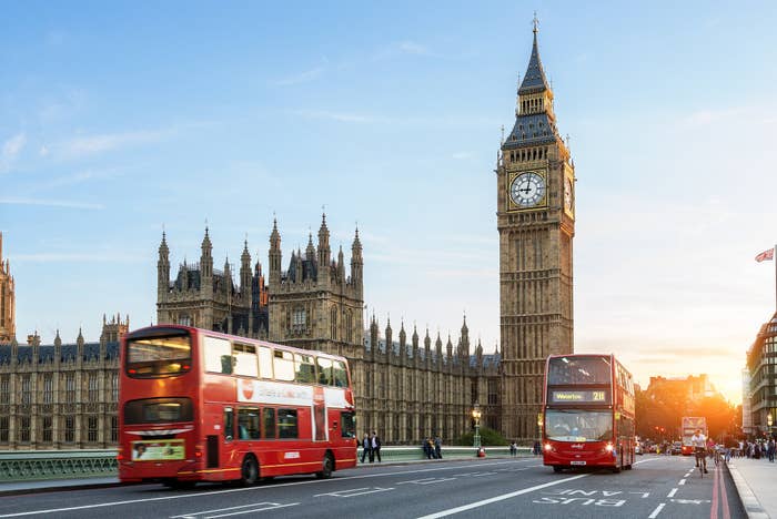 Busses driving past Big Ben in London.