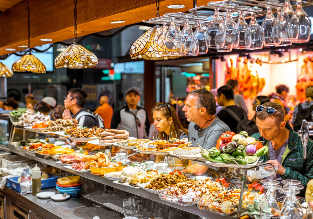 People eating at a tapas bar in the Boqueria.