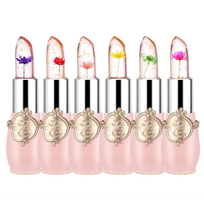 Six pink lipsticks with colorful flowers inside