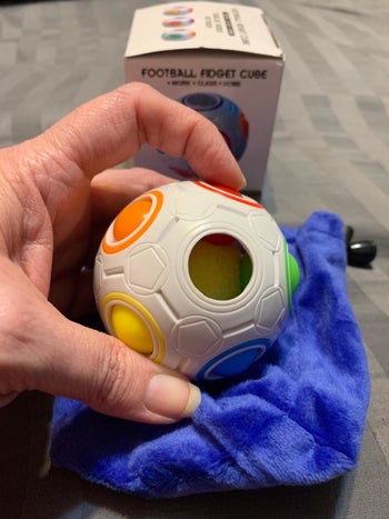 Reviewer playing with the fidget ball