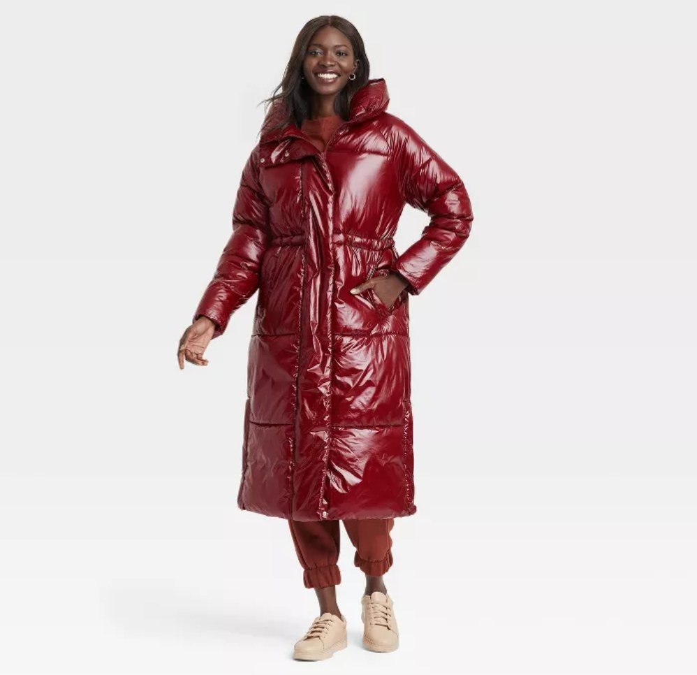 a model wearing the red puffer coat