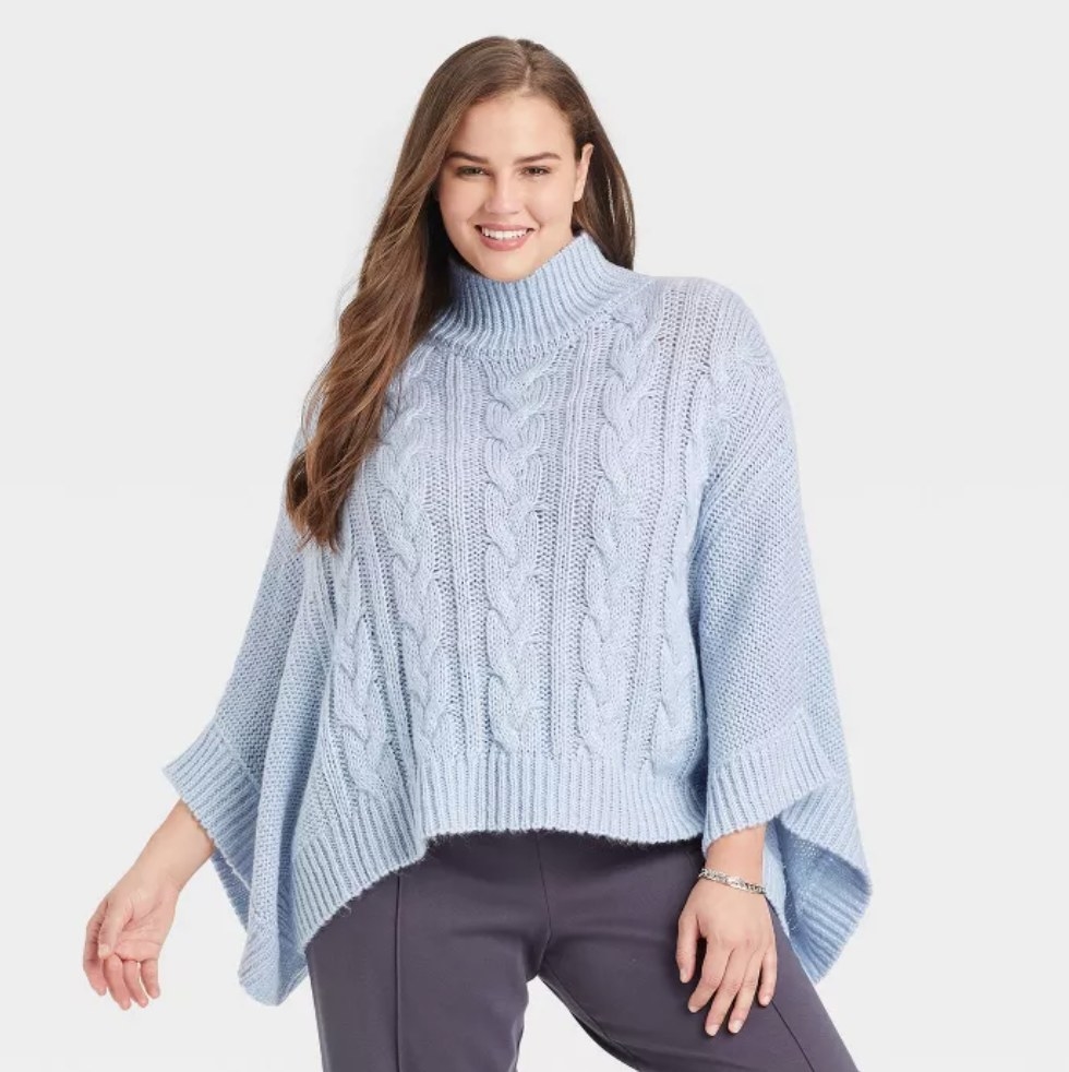a model wearing the blue sweater poncho