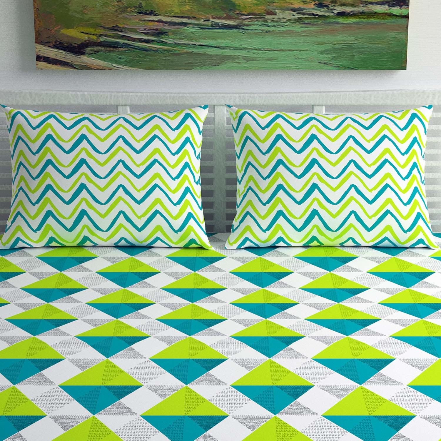 A geometric bedsheet with green and blue triangles on it