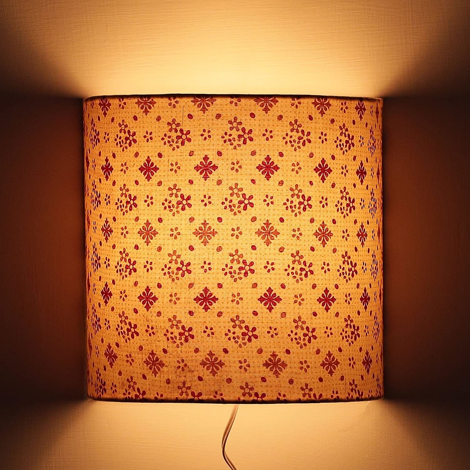 A beige wall-mounted lamp