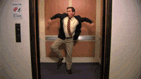 A man dances in the elevator as the doors close.