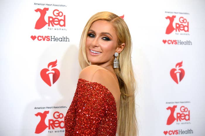 Paris smiles over her shoulder as she poses for photographers at a red carpet event