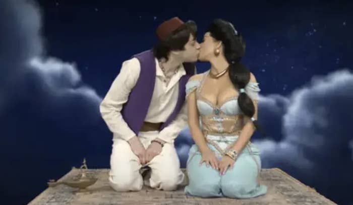 Pete and Kim kissing on a magic flying carpet as Aladdin and Princess Jasmine during an SNL sketch