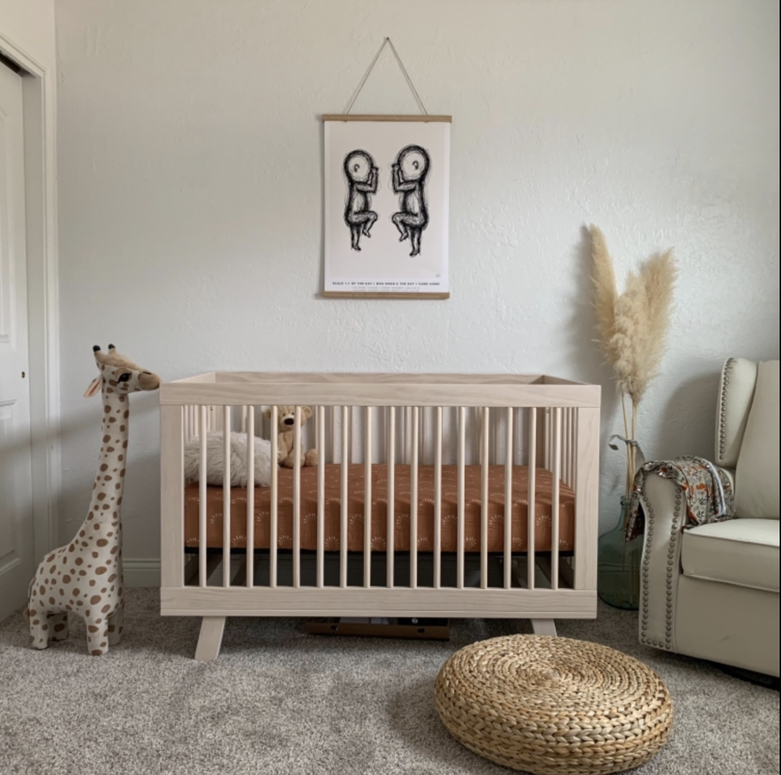 a reviewer photo of the crib in a nursery