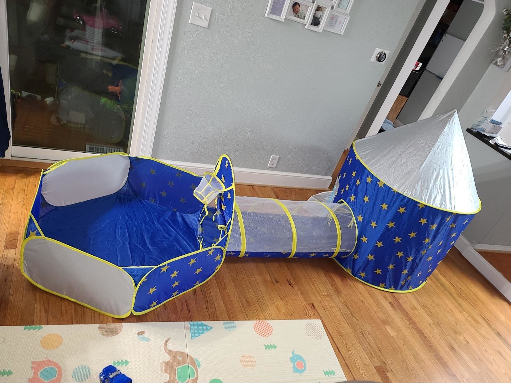 reviewer&#x27;s photo showing the tent, tunnel and ball pit in their living room
