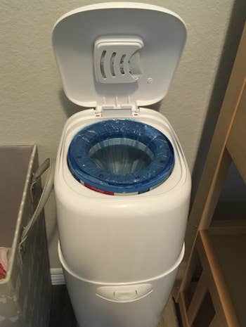 a reviewer photo of the open diaper genie