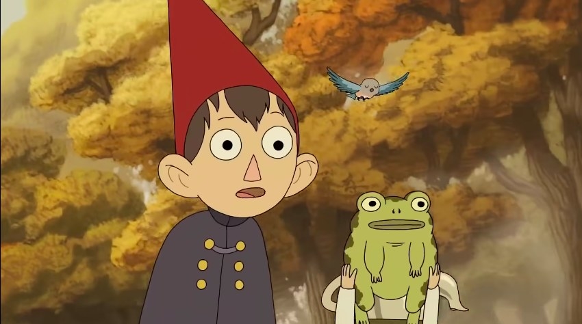 Wirt and Greg walk in the autumnal woods accompanied by frog and bird