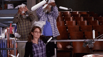 Tina Fey in &quot;30 Rock&quot; dancing as money and tampons fall.