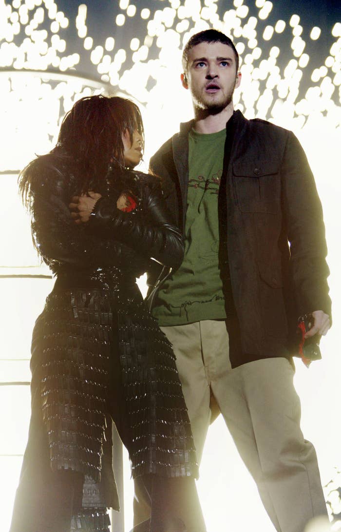 Janet holding onto her top after the piece of fabric was ripped off