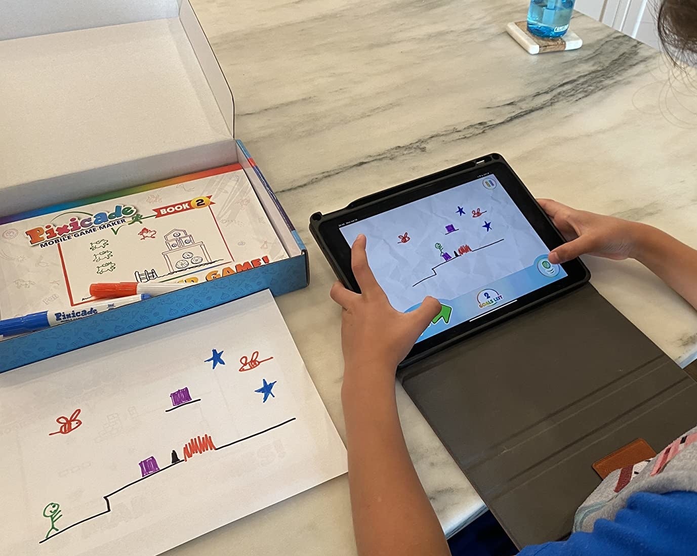 a child's drawing and them playing a game of their drawing on an iPad