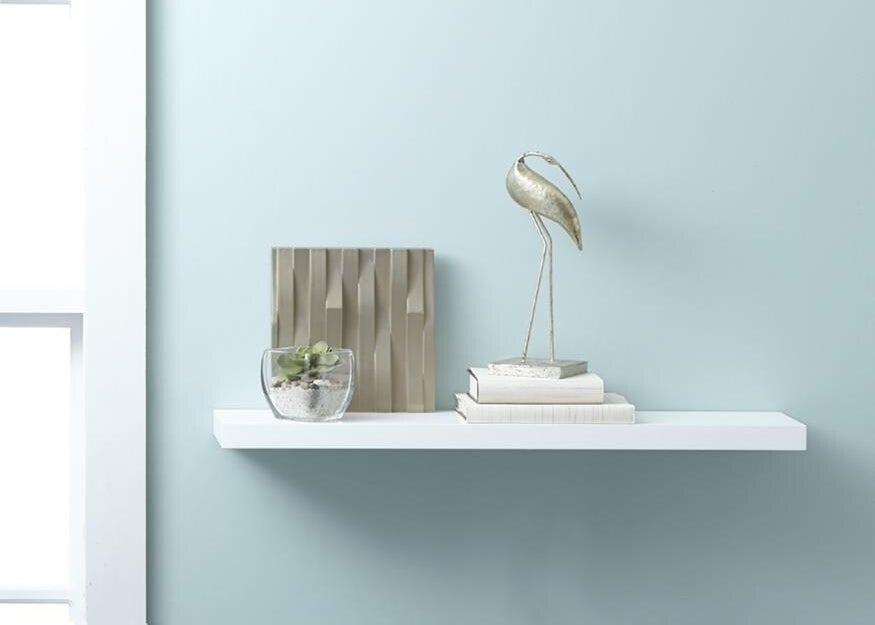 A image of a white hidden bracket shelf mounted onto a wall