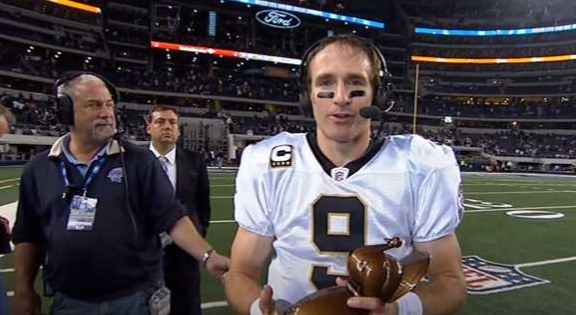 Drew Brees holds a turkey trophy