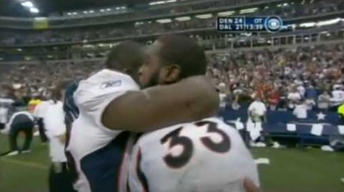 Broncos players embrace after a win