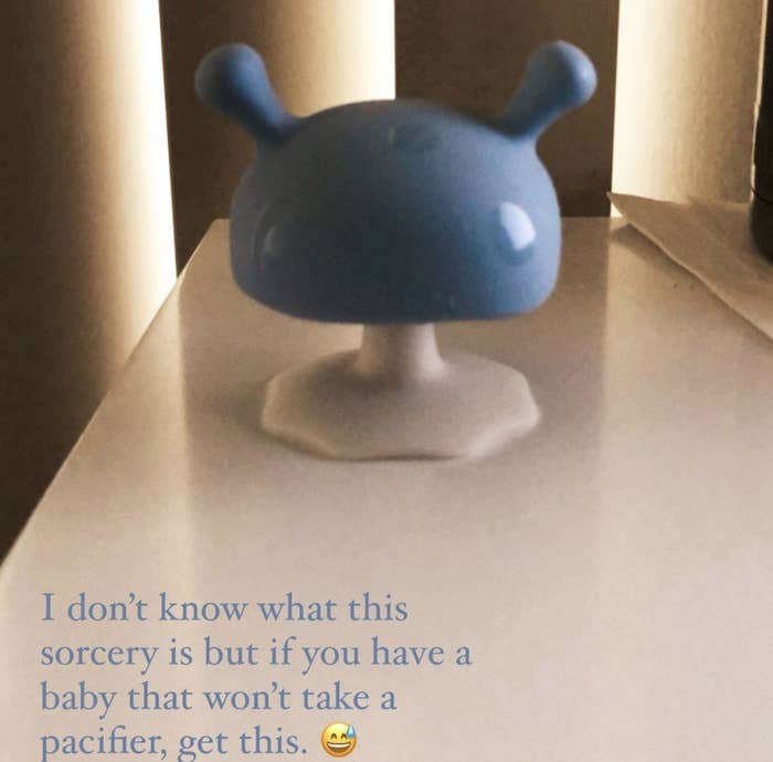 reviewer&#x27;s photo of the blue mushroom-shaped pacifier