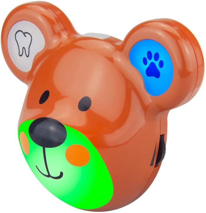 The brown bear-shaped timer with a green glowing mouth and a blue lit up ear