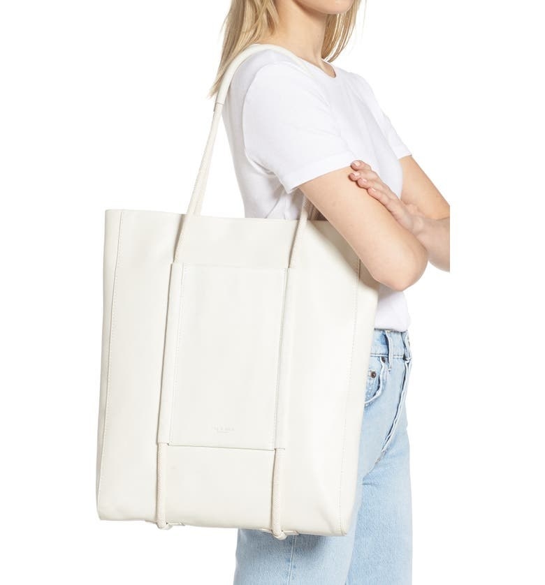 a model carrying the white tote