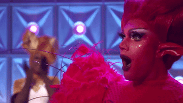 Gif of someone dressed as a devil looking excited